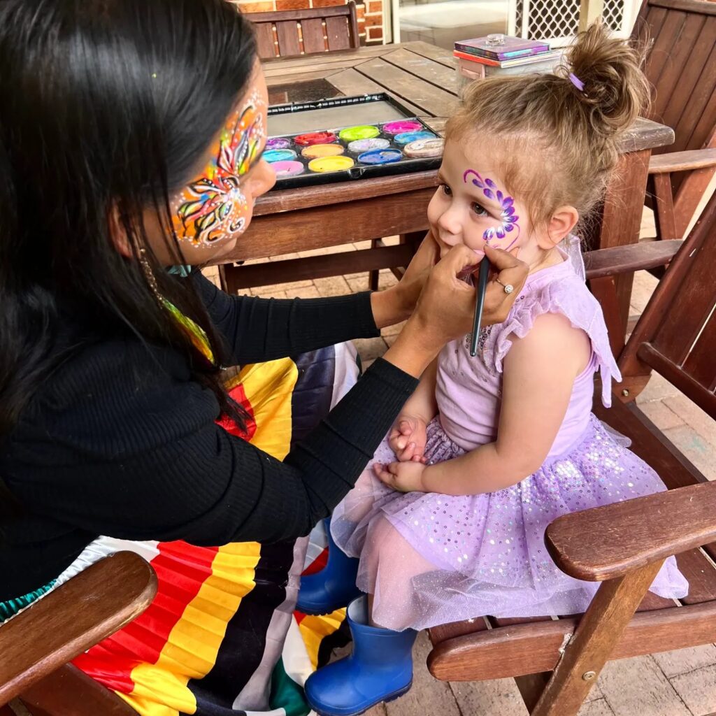 Artist applying kids face painting for birthday party in Sydney
